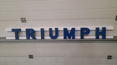 Lot 22 - WOODEN HAND PAINTED TRIUMPH LETTERS 57" X 6"