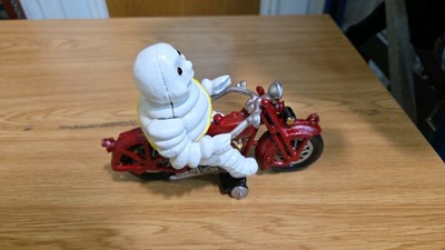 Lot 691 - CAST MICHELIN MAN ON A MOTOR BIKE 8" X 6"