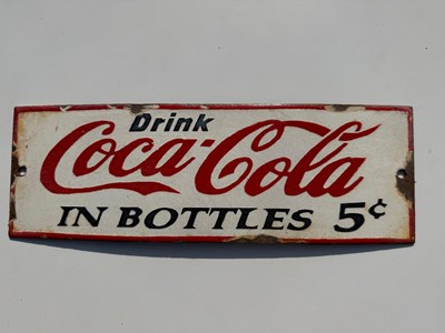 Lot 605 - COCA COLA IN A BOTTLE ENAMEL SIGN 12" X 4"