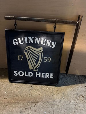 Lot 475 - GUINNESS SOLD HERE , WOODEN DOUBLE SIDED SIGN WITH BRACKET 24" X 24"