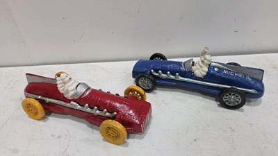 Lot 657 - PAIR OF MICHELIN MEN IN CARS 10" X 4"