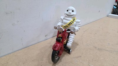 Lot 115 - CAST MICHELIN MAN ON A MOTOR CYCLE 7" X 9"