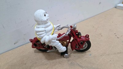 Lot 115 - CAST MICHELIN MAN ON A MOTOR CYCLE 7" X 9"