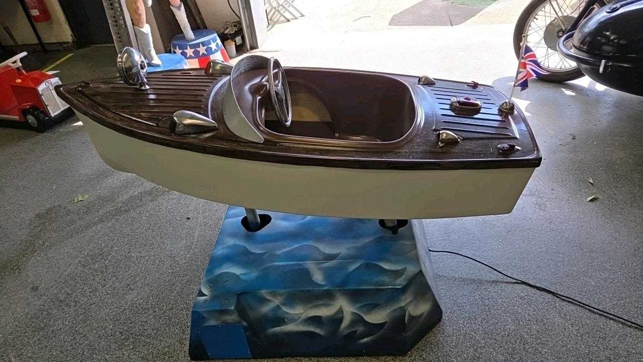 Lot 59 - 1960'S CHILD'S RIDE ON BOAT- IN FULL WORKING ORDER 65" LONG
