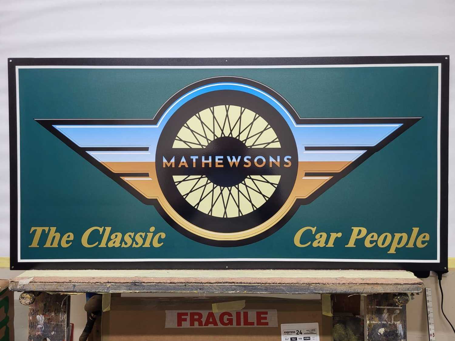 Lot 93 - METAL MATHEWSONS LOGO SIGN 42" X 20"