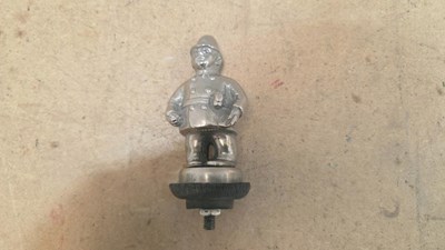 Lot 889 - POLICEMAN CAR MASCOT 4" TALL